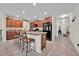 Modern kitchen with dark cabinets, granite countertops, stainless steel appliances, and an island with seating at 10607 Standing Stone Drive, Wimauma, FL 33598