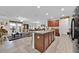 Open kitchen with a bar island that connects to the living area, perfect for entertaining guests at 10607 Standing Stone Drive, Wimauma, FL 33598