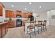 Bright and spacious kitchen with a central island, dark cabinets, and modern appliances at 10607 Standing Stone Drive, Wimauma, FL 33598