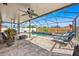Inviting screened-in pool area with comfortable lounge chairs and a relaxing waterfall feature at 10607 Standing Stone Drive, Wimauma, FL 33598
