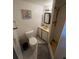 Compact bathroom features a toilet, sink with vanity, and a standing shower stall at 12485 Land St, Largo, FL 33773