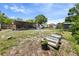 Large backyard with gardening containers, shed, and covered patio area at 215 Melody Ln, Largo, FL 33771