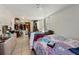 Spacious bedroom featuring tile flooring, and plenty of storage in the large closet at 215 Melody Ln, Largo, FL 33771