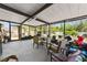Enclosed patio space with metal ceiling, various seating options and backyard views at 215 Melody Ln, Largo, FL 33771