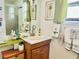 This is a bathroom with palm tree decorations and patterned towels at 9790 66Th N St # 238, Pinellas Park, FL 33782