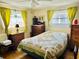 Cozy bedroom featuring a floral-patterned quilt and warm natural lighting through bright, sunny windows at 9790 66Th N St # 238, Pinellas Park, FL 33782