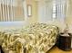 This bedroom features a bed with a tropical-themed comforter at 9790 66Th N St # 238, Pinellas Park, FL 33782