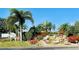 Beautifully landscaped entrance to the community, featuring lush greenery and a tranquil waterfall feature at 9790 66Th N St # 238, Pinellas Park, FL 33782