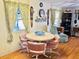 Dining area featuring a round table with pink chairs, illuminated by natural light at 9790 66Th N St # 238, Pinellas Park, FL 33782