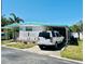 Exterior view of home with a driveway and carport, showcasing the neat landscaping at 9790 66Th N St # 238, Pinellas Park, FL 33782