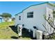Bright home exterior with white siding and a clean, manicured yard. Modern water system is clearly shown at 9790 66Th N St # 238, Pinellas Park, FL 33782