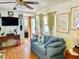 Cozy living room with a comfortable sofa, ceiling fan, and a view of the entrance at 9790 66Th N St # 238, Pinellas Park, FL 33782