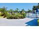 Community pool area with well-maintained landscaping, black metal fencing, and various palm trees for a relaxing atmosphere at 9790 66Th N St # 238, Pinellas Park, FL 33782