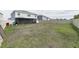 Spacious backyard with partial grass coverage, enclosed by a white fence, offers privacy at 3715 Capri Coast, Plant City, FL 33565