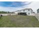 Wide view of expansive backyard enclosed with white fence, showing potential for outdoor activities at 3715 Capri Coast, Plant City, FL 33565
