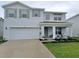 Charming two-story home with a well-manicured lawn, covered porch, and light blue exterior at 3715 Capri Coast, Plant City, FL 33565