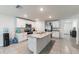 Well-lit kitchen featuring an island, stainless appliances, and tiled floor, for cooking and entertaining at 3715 Capri Coast, Plant City, FL 33565