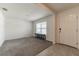 Bright, carpeted living room with a large window and seating, adjacent to the entrance at 3715 Capri Coast, Plant City, FL 33565