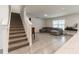 Bright living room with tile floors, a large sectional, and a bar, located adjacent to the staircase at 3715 Capri Coast, Plant City, FL 33565