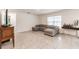 Spacious living room featuring neutral tones, tile flooring, and a comfortable sectional couch at 3715 Capri Coast, Plant City, FL 33565