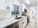 Modern kitchen with white cabinets, stainless steel appliances, and quartz countertops at 7400 Mitchell Ranch Rd, New Port Richey, FL 34655