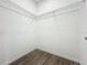 Empty walk-in closet with wire shelving and wood-look floors at 80 Sequoyah Dr, Port Charlotte, FL 33954