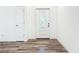 Inviting entryway features a decorative front door, neutral walls and wood grain floors at 80 Sequoyah Dr, Port Charlotte, FL 33954