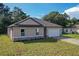New construction single-Gathering home with a two-car garage, stone accents and a well-manicured lawn at 80 Sequoyah Dr, Port Charlotte, FL 33954