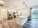 Spacious kitchen with stainless steel appliances, white cabinetry and countertops, and a breakfast bar at 80 Sequoyah Dr, Port Charlotte, FL 33954