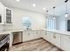 This modern kitchen has quartz countertops, stainless steel appliances, and white cabinetry at 80 Sequoyah Dr, Port Charlotte, FL 33954