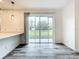 Bright living room with sliding glass doors that lead to the backyard, and modern gray wood flooring at 80 Sequoyah Dr, Port Charlotte, FL 33954