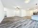 Spacious open living space features wood-look flooring, neutral paint, and seamless transition to the kitchen at 80 Sequoyah Dr, Port Charlotte, FL 33954