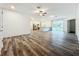 Bright, expansive open-concept living area with wood-look flooring, neutral paint, kitchen, and large windows at 80 Sequoyah Dr, Port Charlotte, FL 33954