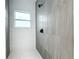 Sleek, tiled shower with a window and contemporary fixtures at 80 Sequoyah Dr, Port Charlotte, FL 33954