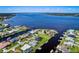 Aerial view of waterfront community with homes featuring private docks, lush landscaping and tranquil waters at 5202 Forbes Ter, Port Charlotte, FL 33981