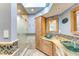 A beautifully remodeled bathroom featuring dual vessel sinks, granite counters, and walk-in shower at 5202 Forbes Ter, Port Charlotte, FL 33981