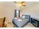 This bedroom has a ceiling fan, bed, and a desk at 5202 Forbes Ter, Port Charlotte, FL 33981