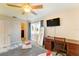 A bedroom featuring a wooden desk and chair, ceiling fan, TV and bed at 5202 Forbes Ter, Port Charlotte, FL 33981