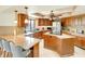 Spacious kitchen with wooden cabinets, granite countertops, stainless steel appliances, and a breakfast bar at 5202 Forbes Ter, Port Charlotte, FL 33981