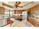 Bright kitchen with stainless steel appliances, granite countertops, wood cabinets and a center island cooktop at 5202 Forbes Ter, Port Charlotte, FL 33981