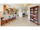 Open-concept kitchen with a breakfast bar, wooden cabinets, and a seamless transition to the living area at 5202 Forbes Ter, Port Charlotte, FL 33981
