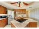Inviting kitchen showcasing wooden cabinets, granite countertops, and modern appliances at 5202 Forbes Ter, Port Charlotte, FL 33981