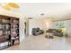 Bright living room with tile flooring, neutral walls, comfortable seating, and natural light from the window at 5202 Forbes Ter, Port Charlotte, FL 33981