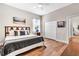 Bright bedroom with hardwood floors, a comfortable bed, and a closet, creating a cozy retreat at 6306 Foxbrook Trl, Parrish, FL 34219