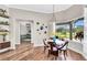 Bright dining room with wood floors, stylish decor, and a large window overlooking the garden at 6306 Foxbrook Trl, Parrish, FL 34219