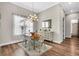 Elegant dining room with hardwood floors, stylish furnishings, natural light, and sophisticated décor at 6306 Foxbrook Trl, Parrish, FL 34219