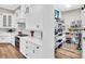 Well-designed kitchen with pantry storage, white cabinets, stainless steel appliances, and wood flooring at 6306 Foxbrook Trl, Parrish, FL 34219