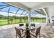 Inviting screened-in patio with a dining set overlooking the pool and green lawn at 6306 Foxbrook Trl, Parrish, FL 34219