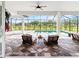 Inviting screened-in pool patio with comfortable seating, pavers and lush landscaping at 6306 Foxbrook Trl, Parrish, FL 34219