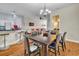 Open-concept dining area with elegant chandelier, breakfast bar, and seamless transition to the kitchen and living spaces at 8614 Miramar Terrace Cir, Temple Terrace, FL 33637